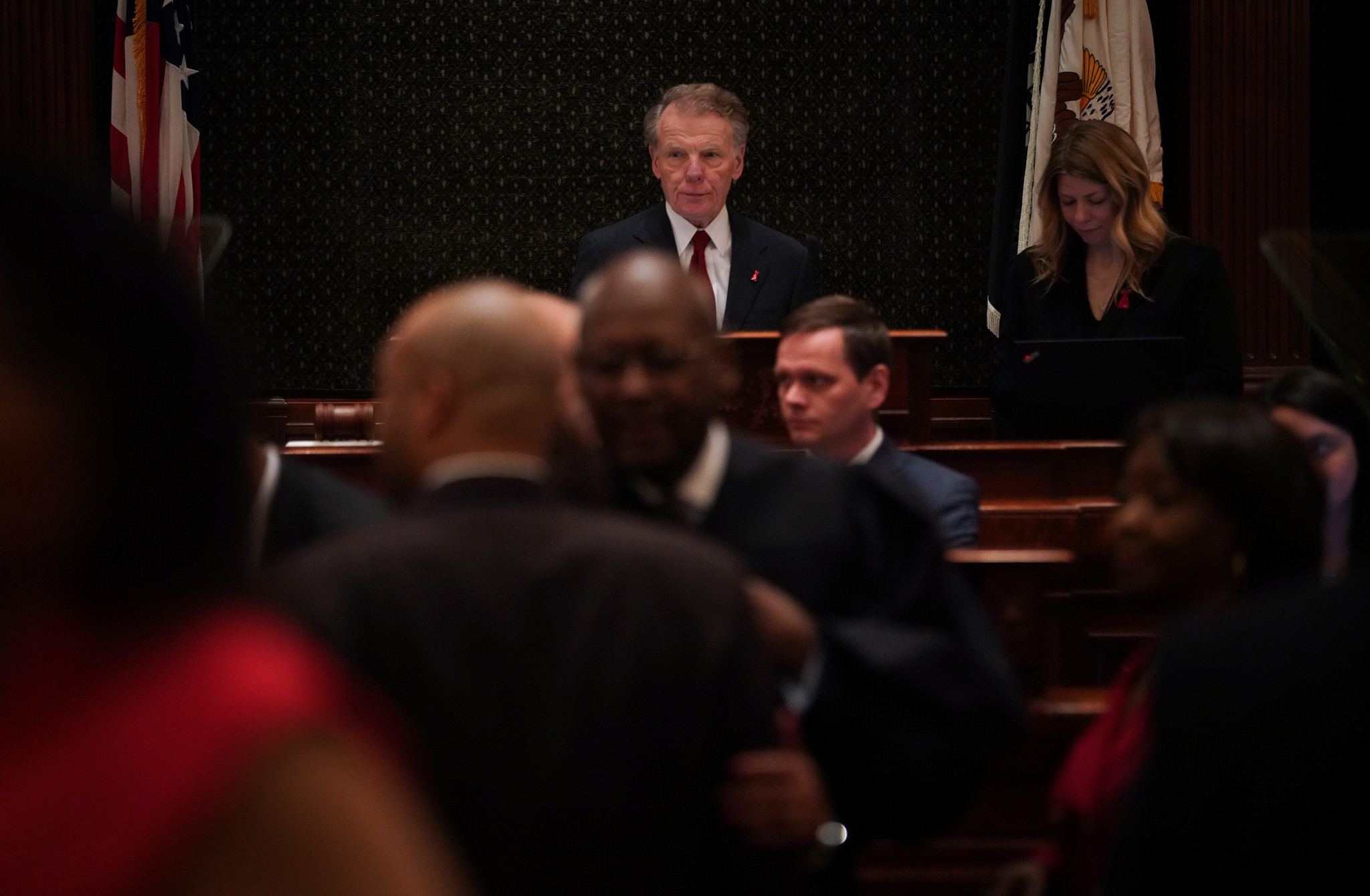 Speaker Michael Madigan stands over lawmakers on the House floor...