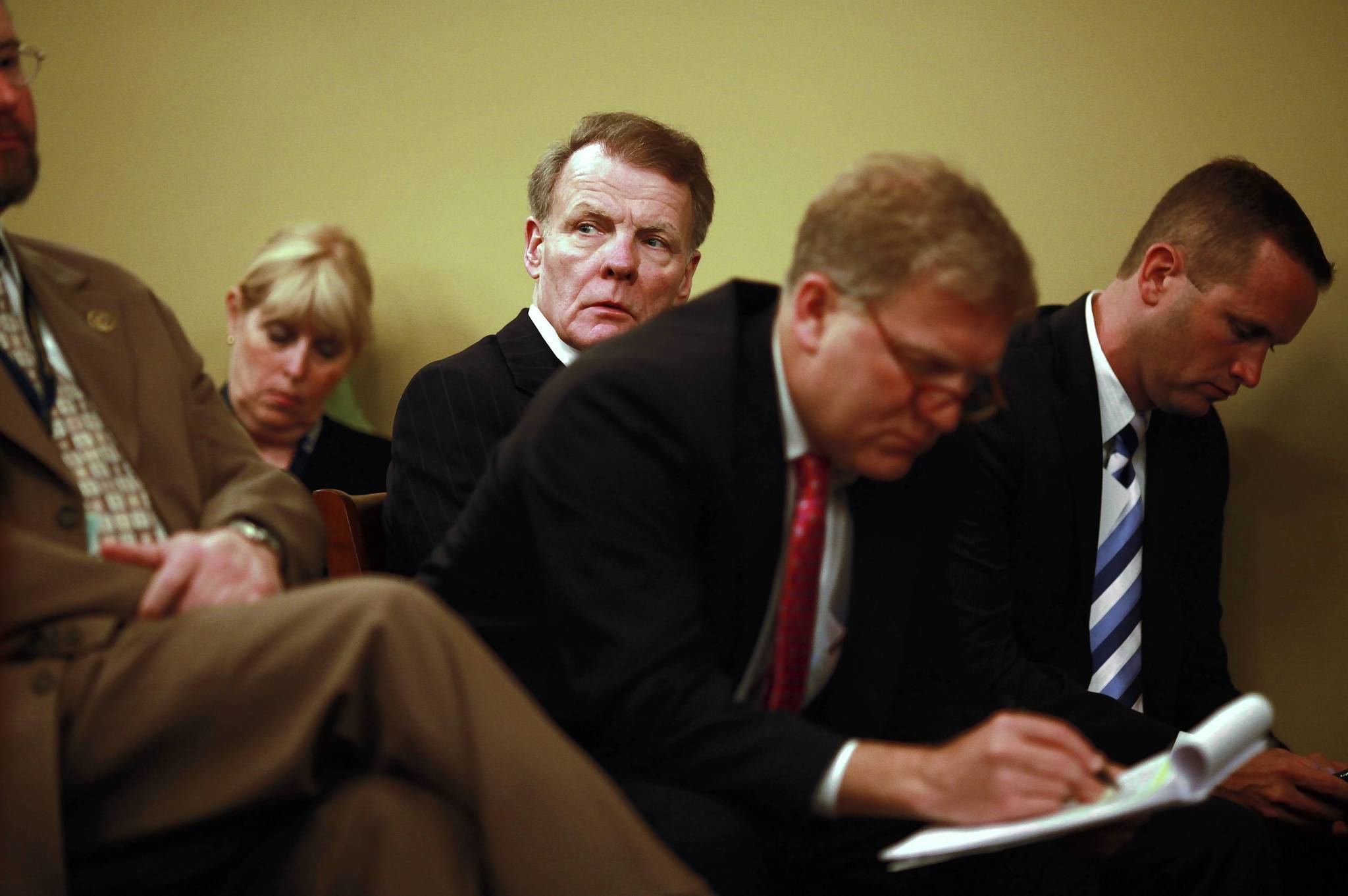 House Speaker Michael Madigan, center, listens after speaking to the...