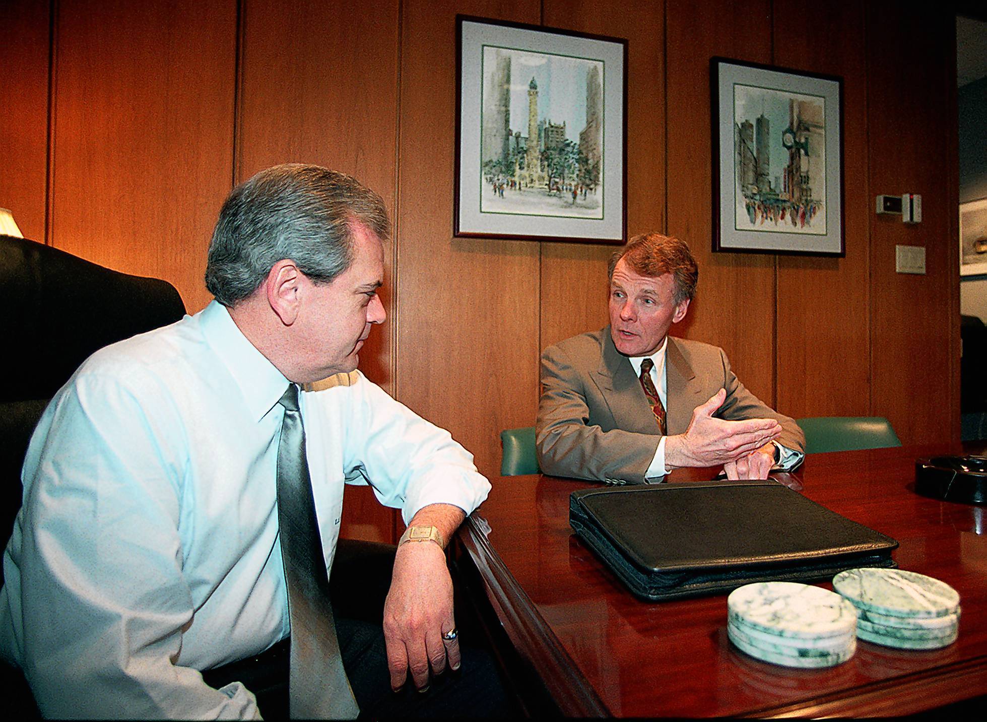 House Speaker Michael Madigan, right, talks with Earl Oliver, president...