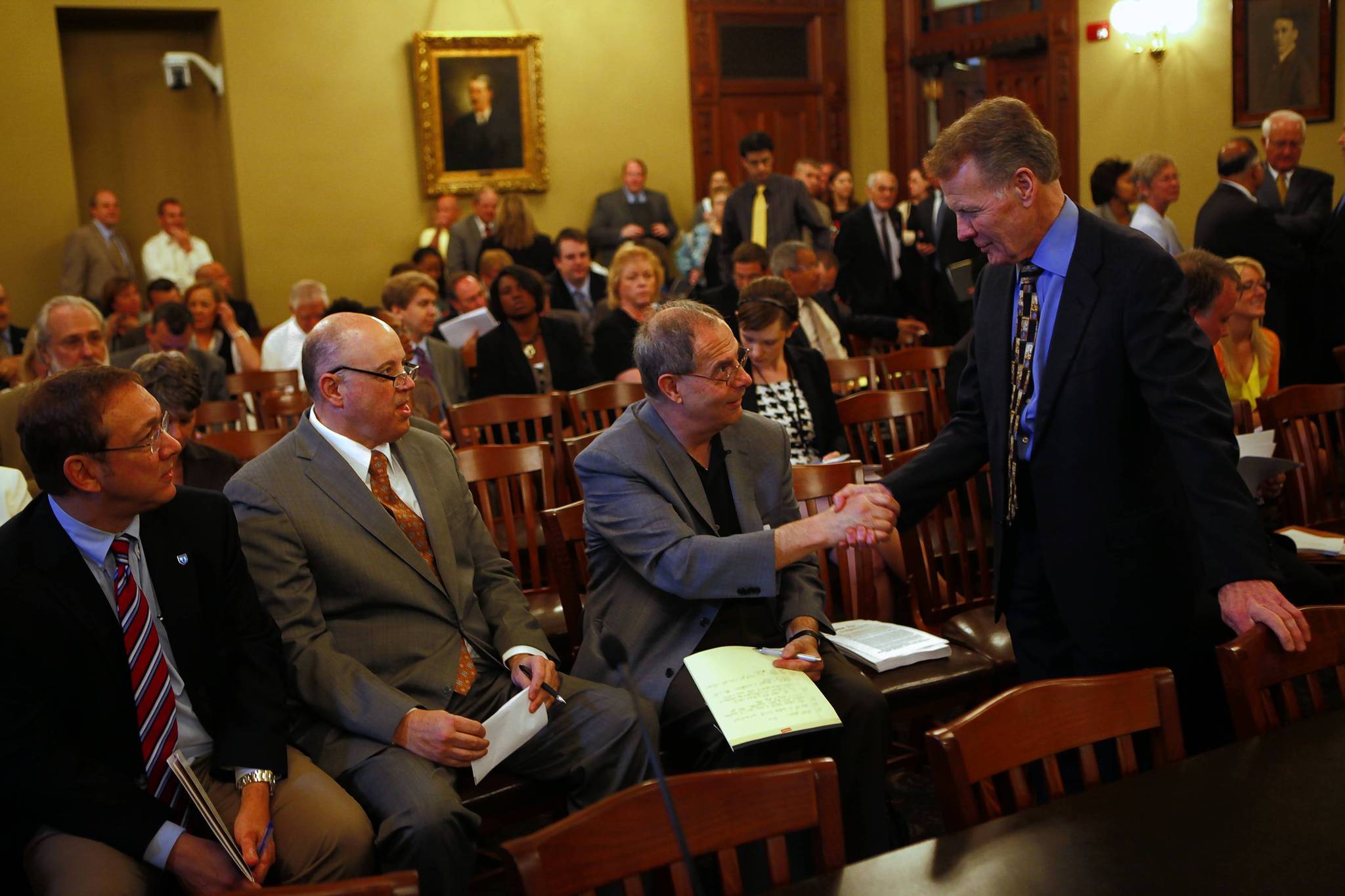 House Speaker Michael Madigan greets AFSCME's Henry Bayer along with...