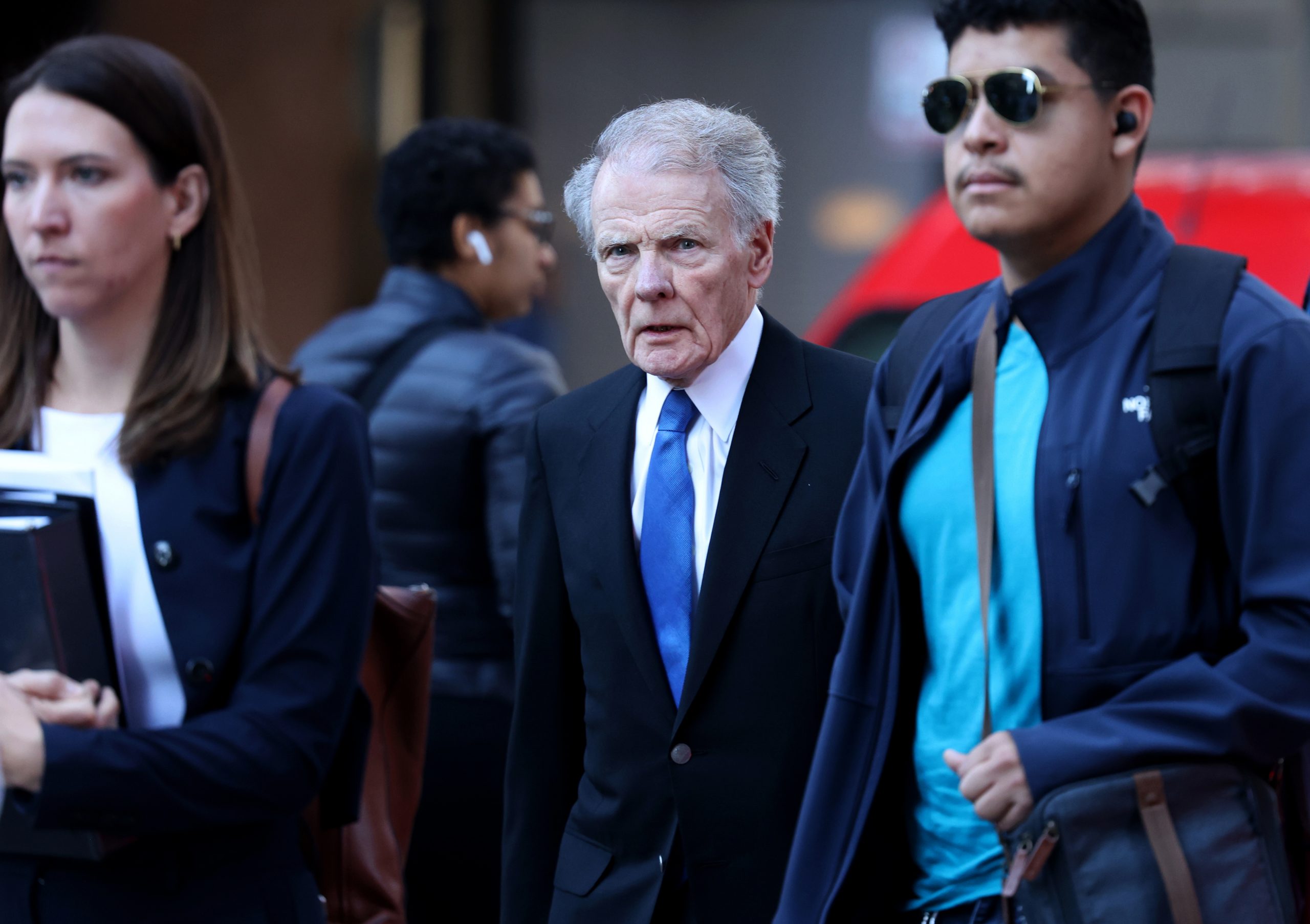 Former Illinois House Speaker Mike Madigan walks across Dearborn Street...