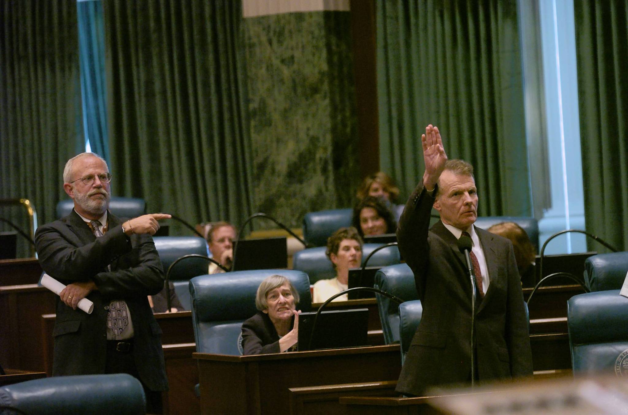 House Speaker Michael Madigan, right, tries to get the attention...