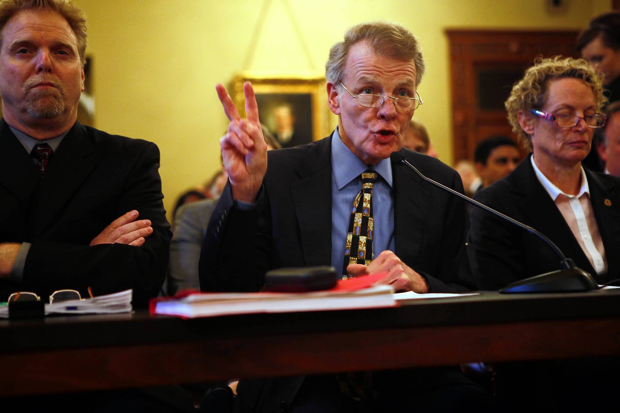 House Speaker Michael Madigan, center, along with his research and...