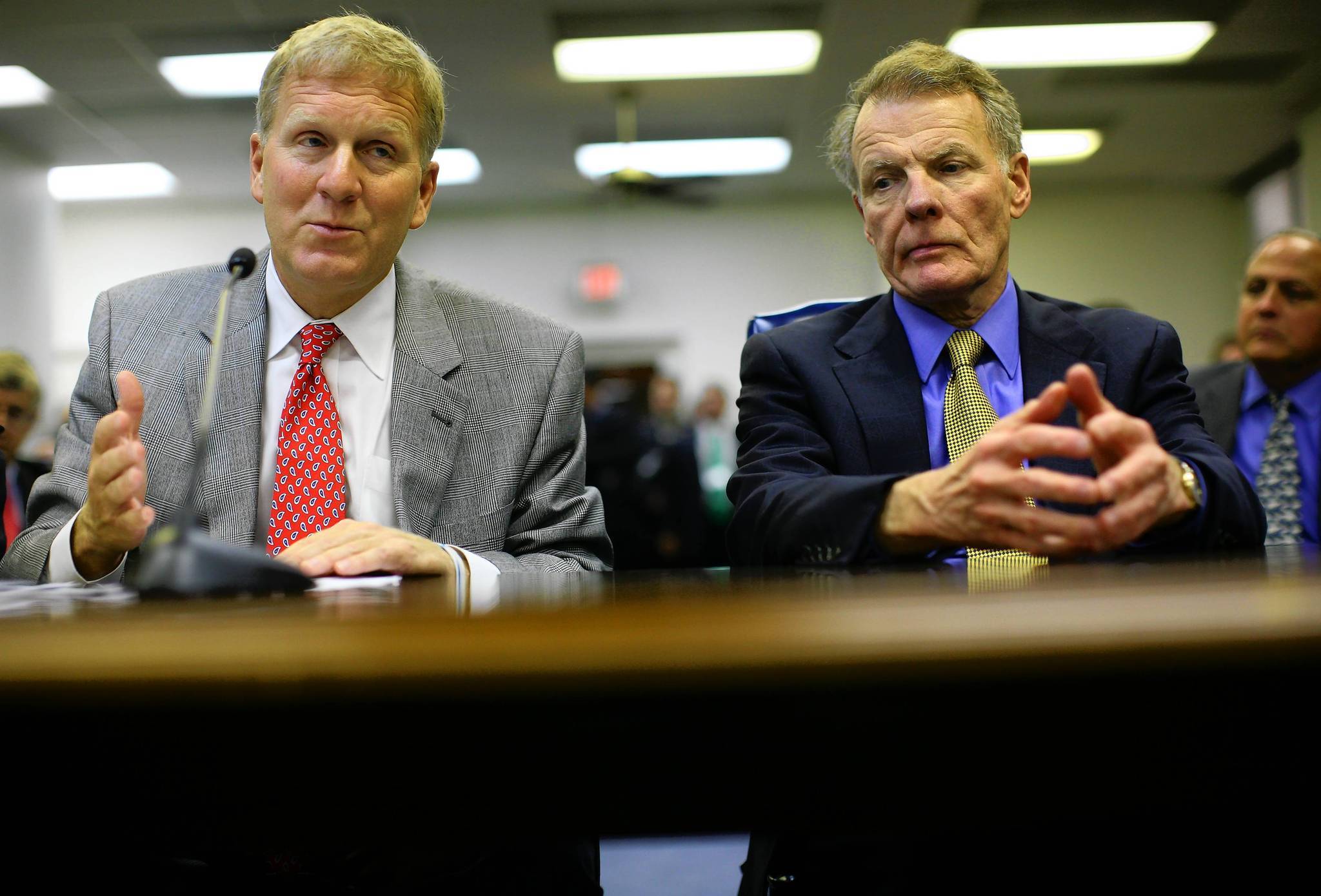 Minority Leader Tom Cross, left, joined by Speaker Michael Madigan,...