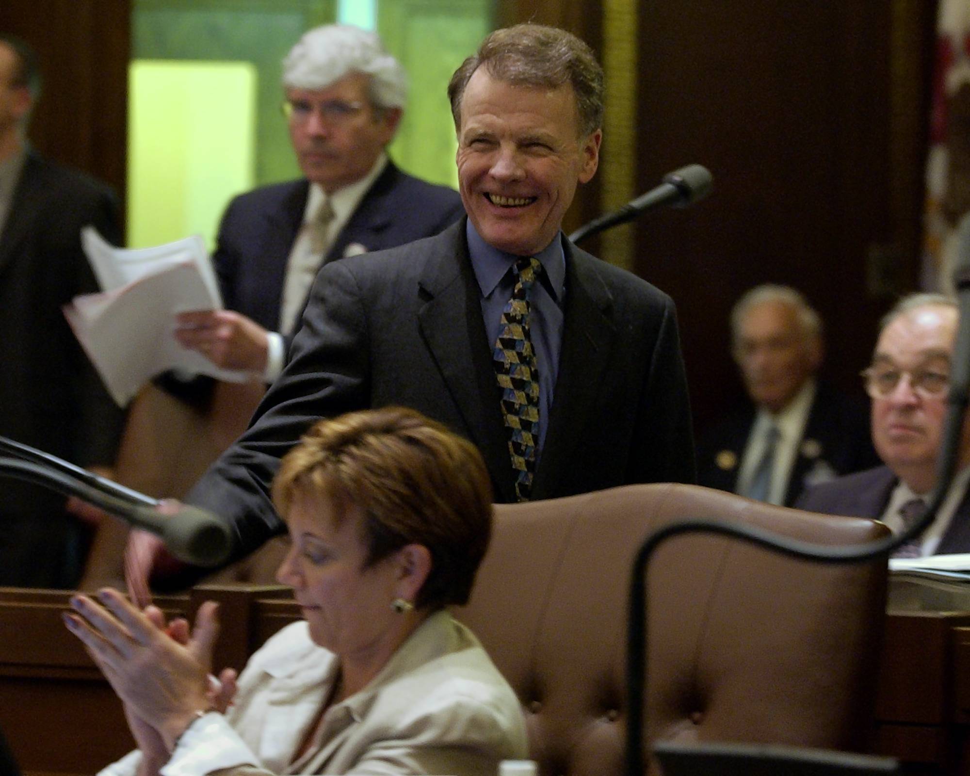 House Speaker Michael Madigan acknowledges applause from Sen. Debbie Halvorson,...