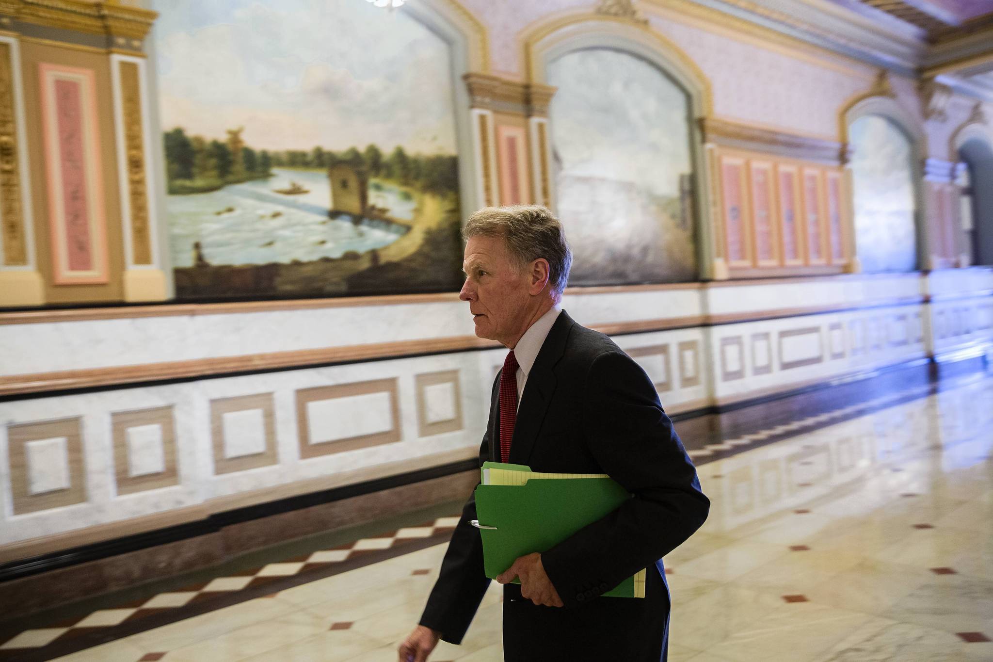 House Speaker Michael Madigan walks through the state Capitol in...